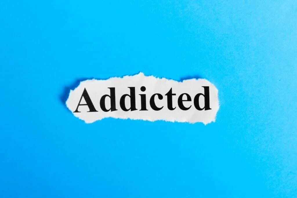 The word “addicted” appears on blue background.
