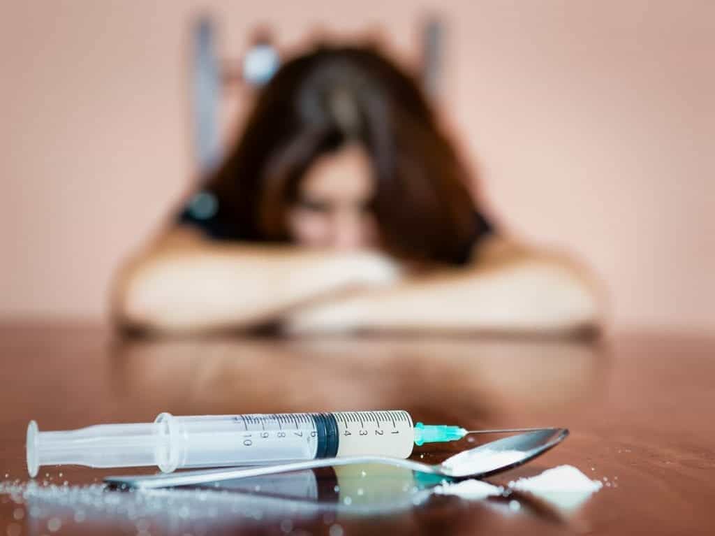 A woman struggles with withdrawal symptoms while detoxing from heroin.