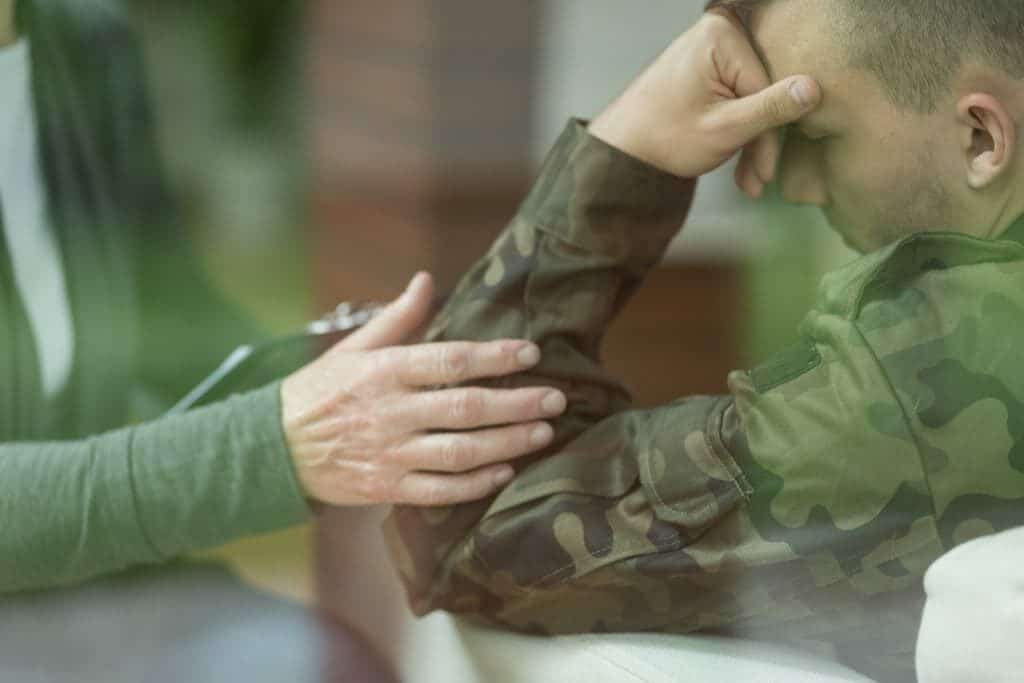 A soldier works with his therapist to treat PTSD.