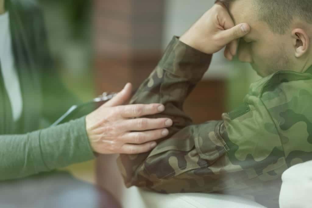 A soldier works with his therapist to treat PTSD.